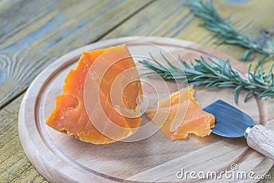 Mimolette cheese on the wooden board Stock Photo