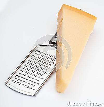 Wedge of Parmesan cheese or grana with grater. Stock Photo