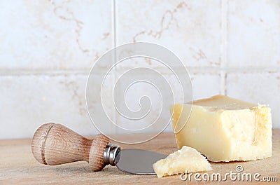 A wedge of parmigiano, with knife Stock Photo