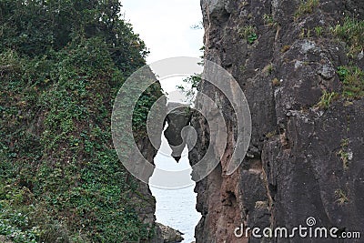 A wedge-shaped rock between two giant rocks or Benkei no Hasamiiwa at Sado island, Japan Stock Photo