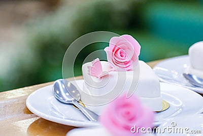 White cupcakes decorated with pink flowers. Stock Photo