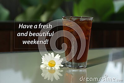 Weekend inspirational quote - Have a fresh and beautiful weekend. A glass of tea with ice and flower on white tabke. Stock Photo