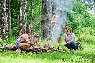 Weekend in forest benefits. Roasting marshmallows popular group activity around bonfire. Company friends prepare roasted Stock Photo