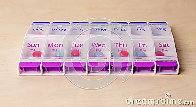 Weekly pills case. Plastic, portable organizer with tablets and vitamins. Health care concept Stock Photo