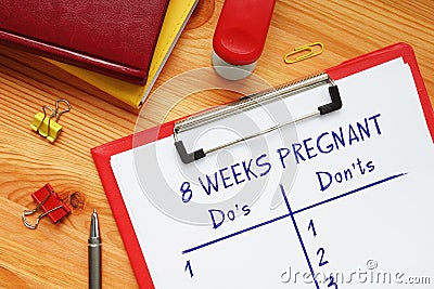 8 WEEKS PREGNANT Do`s and Don`ts phrase on the sheet Stock Photo