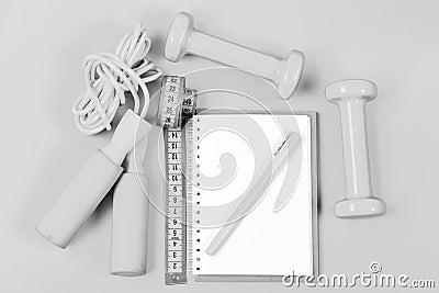 Weight loss and active lifestyle concept. Notepad and fitness tools. Block note, pen with sports equipment Stock Photo