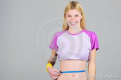 Weight loss. Fitness and health. Female slim waist belly and tape measure. Athlete fitness coach training. Trying to Stock Photo