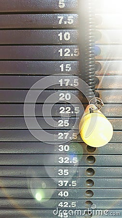 Weight stack scale with graduation in kilograms with pin and sunbeam Stock Photo