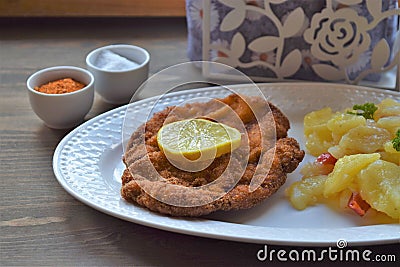 Weiner schnitzel with potato salad on a wooden background Stock Photo