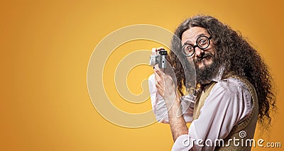 Weird nerd taking a photo with a tiny camera Stock Photo