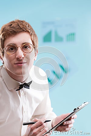 weird nerdy man clutches notepad in office Stock Photo