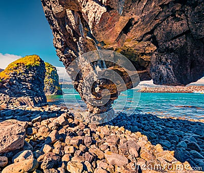 Weird shapes of basalt columns on the shore of small fishing village - Arnarstapi or Stapi. Stock Photo