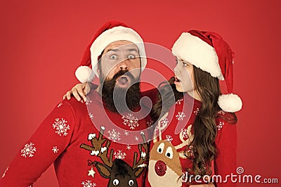 Weird things going on. Father and daughter winter sweaters celebrate new year. Happy family hug. Concentrated faces Stock Photo