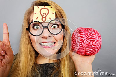 Weird woman holding brain having idea Stock Photo