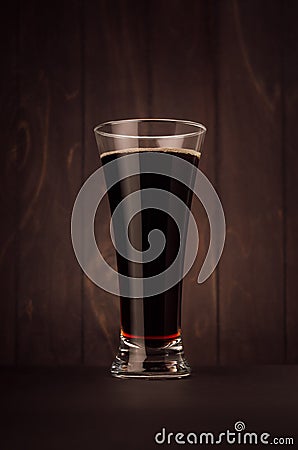 Weizen beer glass porter or red ale on dark wood board,vertical. Template for advertising, design, branding identity, restaurant m Stock Photo