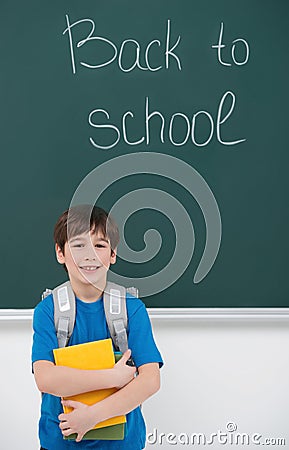 Welcome back to school! Cheerful little schoolboy holding the bo Stock Photo