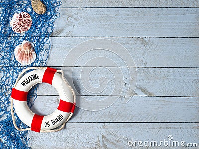 Welcome on Board - lifebuoy with text and shells on wooden background Stock Photo