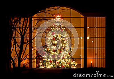 Welcome Home Christmas Tree in Window Stock Photo