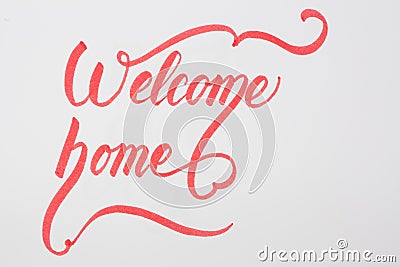 Welcome Home creative brush lettering on white background with copy space. Stock Photo