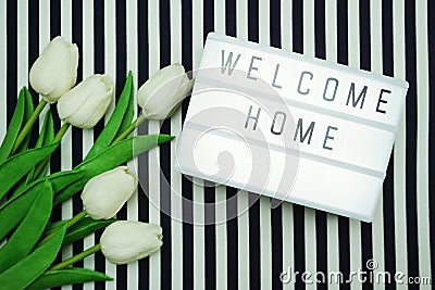 Welcome Home Light box letters Flat Lay with tulip flower bouquet Stock Photo