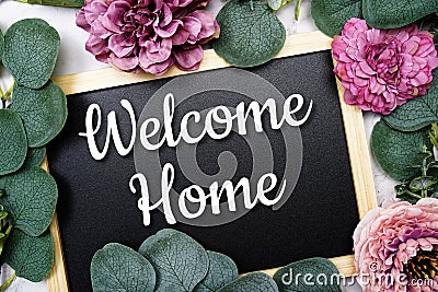 Welcome Home text on blackboard and eucalyptus leaves decoration on marble background Stock Photo