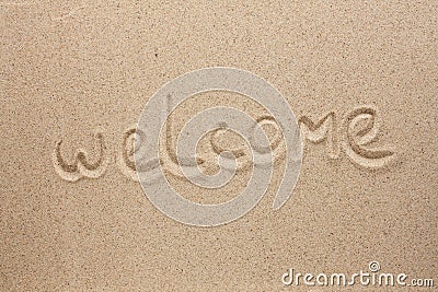 Welcome is the inscription by hand on the sand Stock Photo