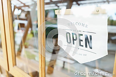 Welcome Open sign broad through the glass of window at coffee shop. shop ready to service, cafe restaurant, retail store, small Stock Photo