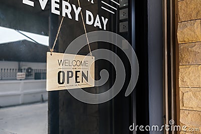 Welcome open sign front glass door store. Reopening business startup after coronavirus the lockdow Stock Photo