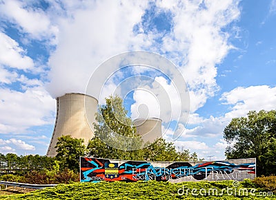 Welcome sign and cooling towers of the nuclear power plant of Nogent-sur-Seine, France Editorial Stock Photo