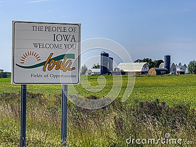 Welcome Sign for Iowa in front of a local Farm Editorial Stock Photo