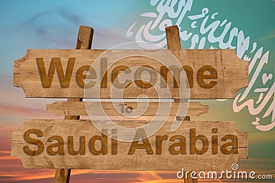 Welcome to Saudi Arabia sign on wood background with blending national flag Stock Photo