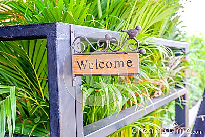 Welcome wooden label in front of the door on natural background Stock Photo
