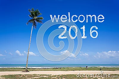 Welcome 2016 word cloud in blue sky at tropical beach Stock Photo