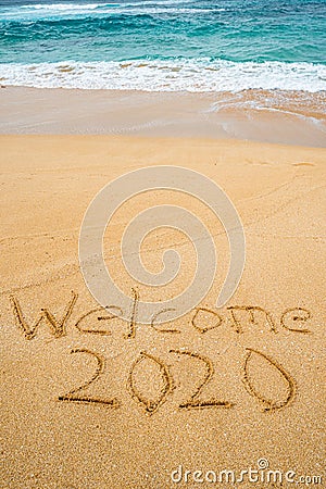 Welcome 2020 written in the sand Stock Photo