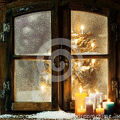 Welcoming Christmas window in a log cabin Stock Photo