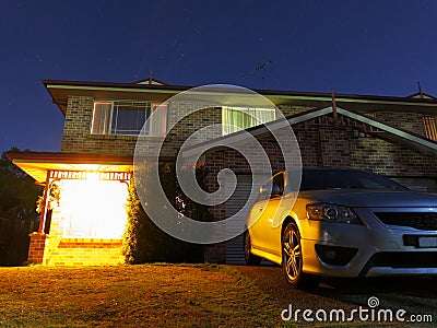 Welcoming home at night with parked car Stock Photo