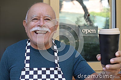 Welcoming senior waiter giving coffee away Stock Photo