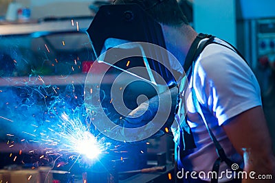 Welder in factory on the machine Stock Photo