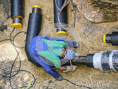 Welder joining heating installation pipes Stock Photo