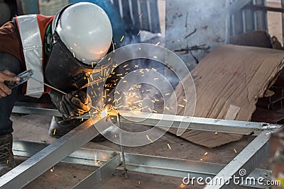 The welder in the operate,Employee welding U-steel using welder machine Editorial Stock Photo