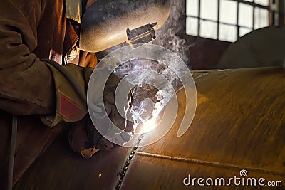 Welder performs welding large diameter pipe Stock Photo