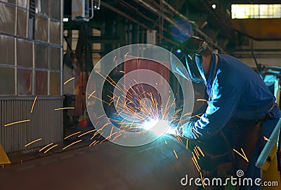 Welder performs welding large diameter pipe Stock Photo