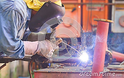 Welder with safety equipment is welding steel pipe for use in oil pipeline system renovate work in tanker ship Stock Photo