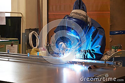 Welder in safety mask at work Editorial Stock Photo