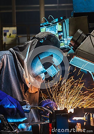 Welder, welding automotive part in a car factory Stock Photo