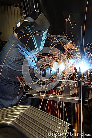 Welder welding in an industrial factory Stock Photo