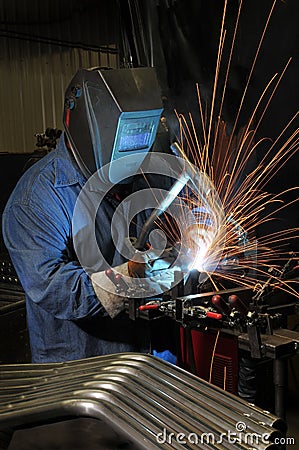 Welder welding in an industrial factory Stock Photo