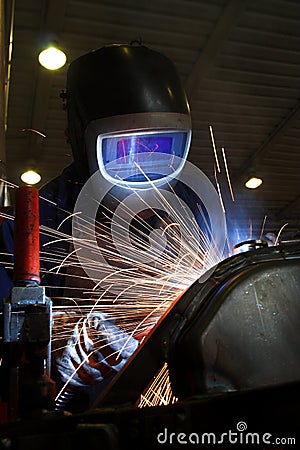 Welder welding a metal part Stock Photo