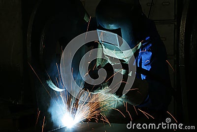 Welder and welding sparks Stock Photo
