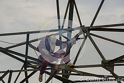 Welder work at high Electric high voltage pole 230 Kv Stock Photo